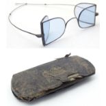 A cased pair of late Victorian D-spectacles, also known as railway spectacles / glasses, with a
