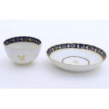 A Fight & Barr Worcester fluted tea bowl and saucer with gilt thistle motifs and a blue and gilt