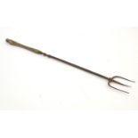 A 19thC toasting fork, approx. 19 3/4" high Please Note - we do not make reference to the