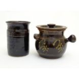 A studio pottery pot and cover with handle and slipware decoration by Peter Arnold, marked under.