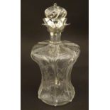 An early 20thC cut glass decanter with floral detail and silver collar hallmarked London 1907