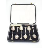 A set of 6 silver plate grapefruit spoons with Art Nouveau style decoration. The case 8 1/2" wide