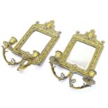 A pair of Victorian twin branch girandoles with mirrored back plates and embossed brass surrounds