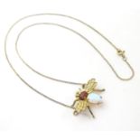 A silver gilt necklace with gilt metal pendant formed as a winged insect / bug, the body set with