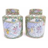 A pair of Chinese jars and covers profusely decorated with flowers and foliage, with two lobed