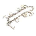 A silver and white metal charm bracelet with charms. Approx 7" long Please Note - we do not make