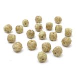 A quantity of Oriental carved hardstone beads with roundel decoration. Approx. 1" (19) Please Note -