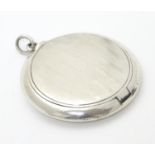 A Continental .900 silver compact / patch box of pendant form with engine turned decoration and