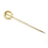 A 9ct gold stick pin surmounted by a horseshoe. Approx 2" long Please Note - we do not make