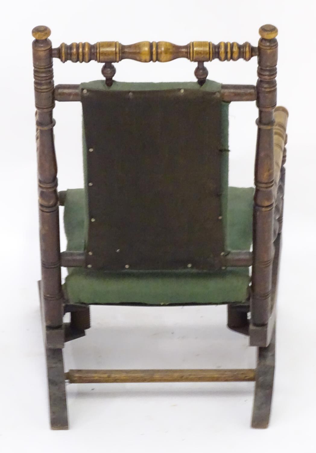 An early 20thC childs rocking chair with a ring turned frame above a cloth seat and turned spindle - Image 2 of 4