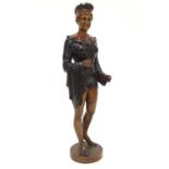 A 20thC carved wooden sculpture modelled as a woman wearing a jester style outfit with polychrome