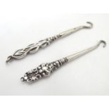 Two silver handled glove button hooks. The longest 3" long Please Note - we do not make reference to