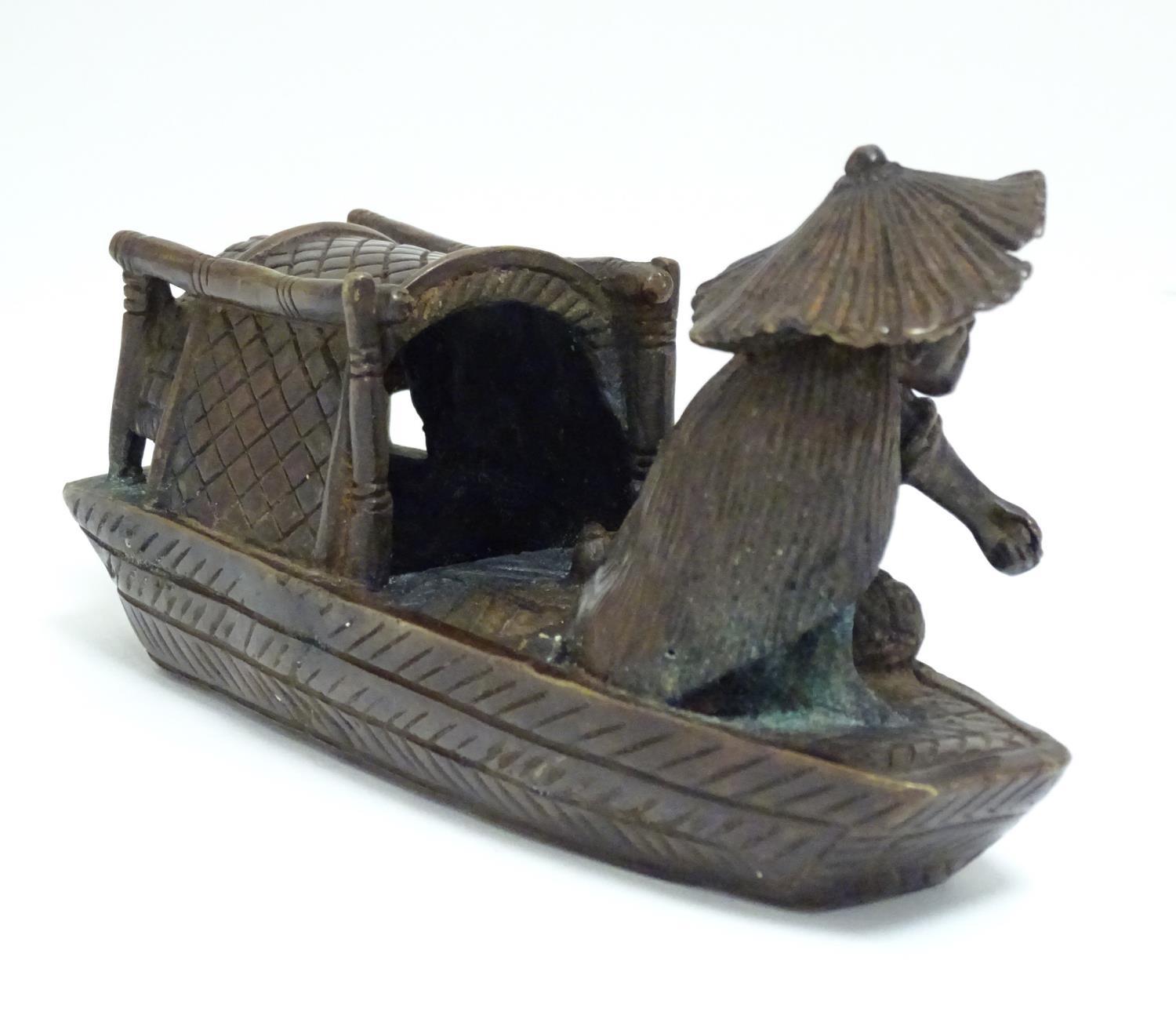An Oriental bronze model of a fishing boat with a figure fishing. Approx. 6 1/2" long Please - Image 4 of 7