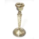 A silver candlestick hallmarked Birmingham 1977 maker Pinder Brothers. 5 1/2" high Please Note -