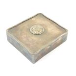 A silver table top cigarette box with wood lined interior, the lid with inset coin / medallion