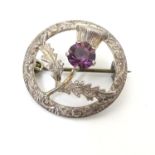 A silver brooch with Scottish thistle decoration set with Amethyst coloured stone. Maker WBs. Approx
