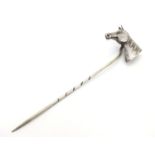 A white metal stick pin surmounted by horsehead decoration. 3" long overall Please Note - we do