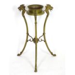 A 20thC brass tripod jardiniere stand with dragon head detail. Approx. 31" high Please Note - we