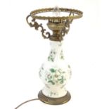 A 20thC table lamp, the ceramic baluster shaped body with floral detail . The whole approx 17"