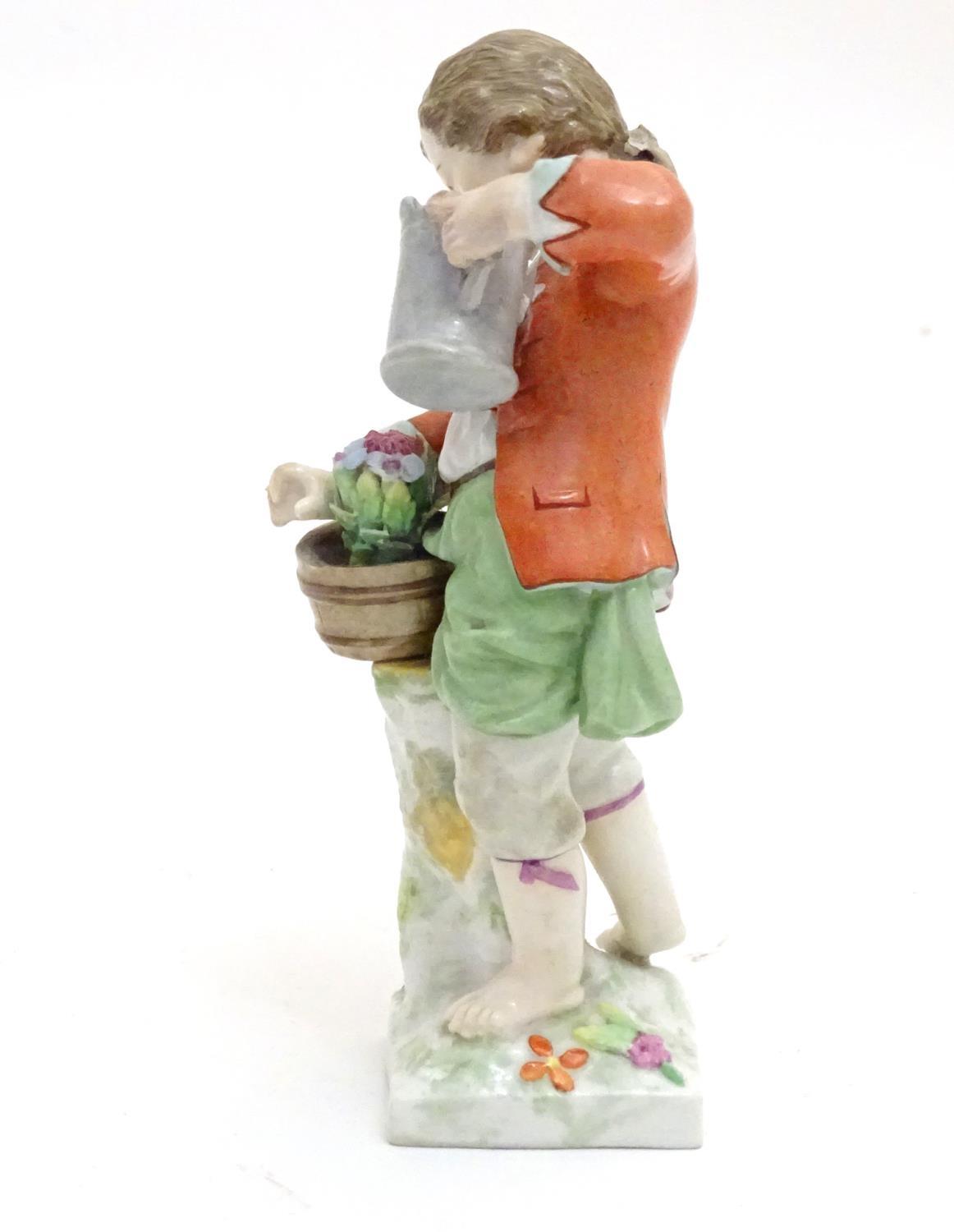 A Continental porcelain figure modelled as a boy with a watering can tending to a pot of flowers. - Image 6 of 6