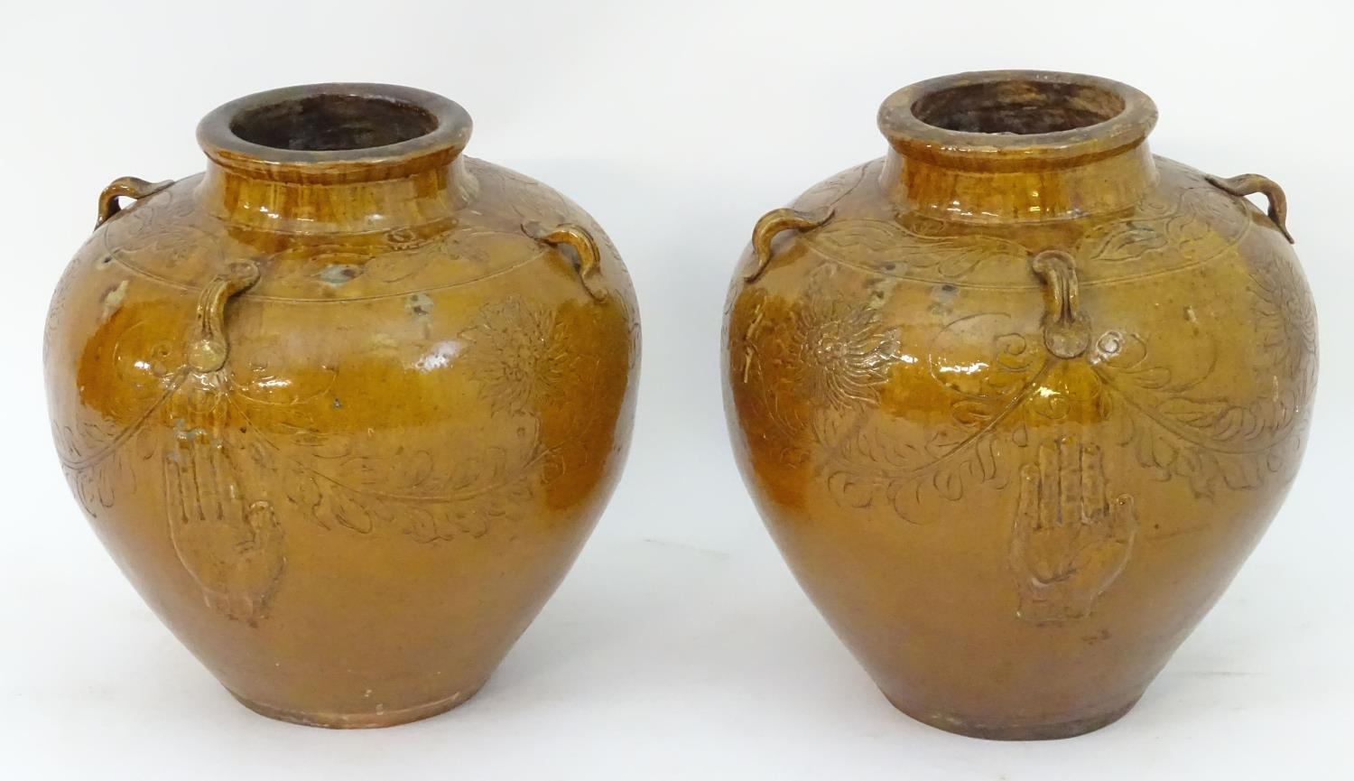A pair of large Chinese earthenware salt glaze vases with applied handles and incised decoration