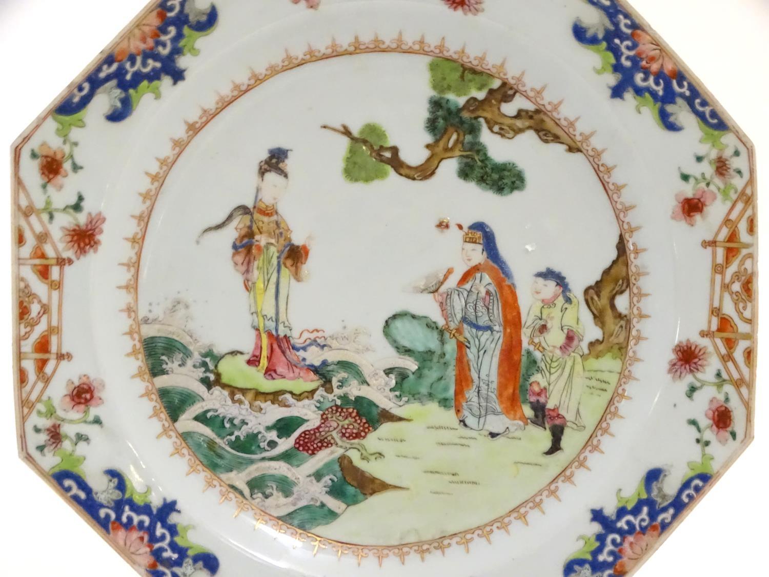 A Chinese plate of octagonal form decorated in famille rose depicting figures in a coastal landscape - Image 2 of 5