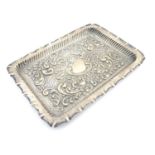 A Victorian silver dressing table tray with embossed decoration, hallmarked Birmingham 1900, maker