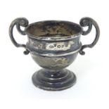 A Small silver trophy cup with twin handles. Hallmarked Chester 1899 maker William Aitken. Approx.