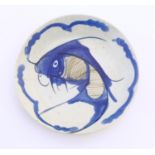 An Oriental blue and white plate with hand painted carp fish decoration. Character marks under.