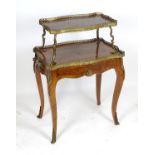 A late 19thC kingwood etagere with two gilt lined tiers and pierced galleries above shaped