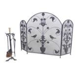 A 20thC three fold spark guard / fire screen with wrought iron floral, foliate and bird detail.