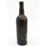 A 19thC olive green glass bottle 12" high Please Note - we do not make reference to the condition of