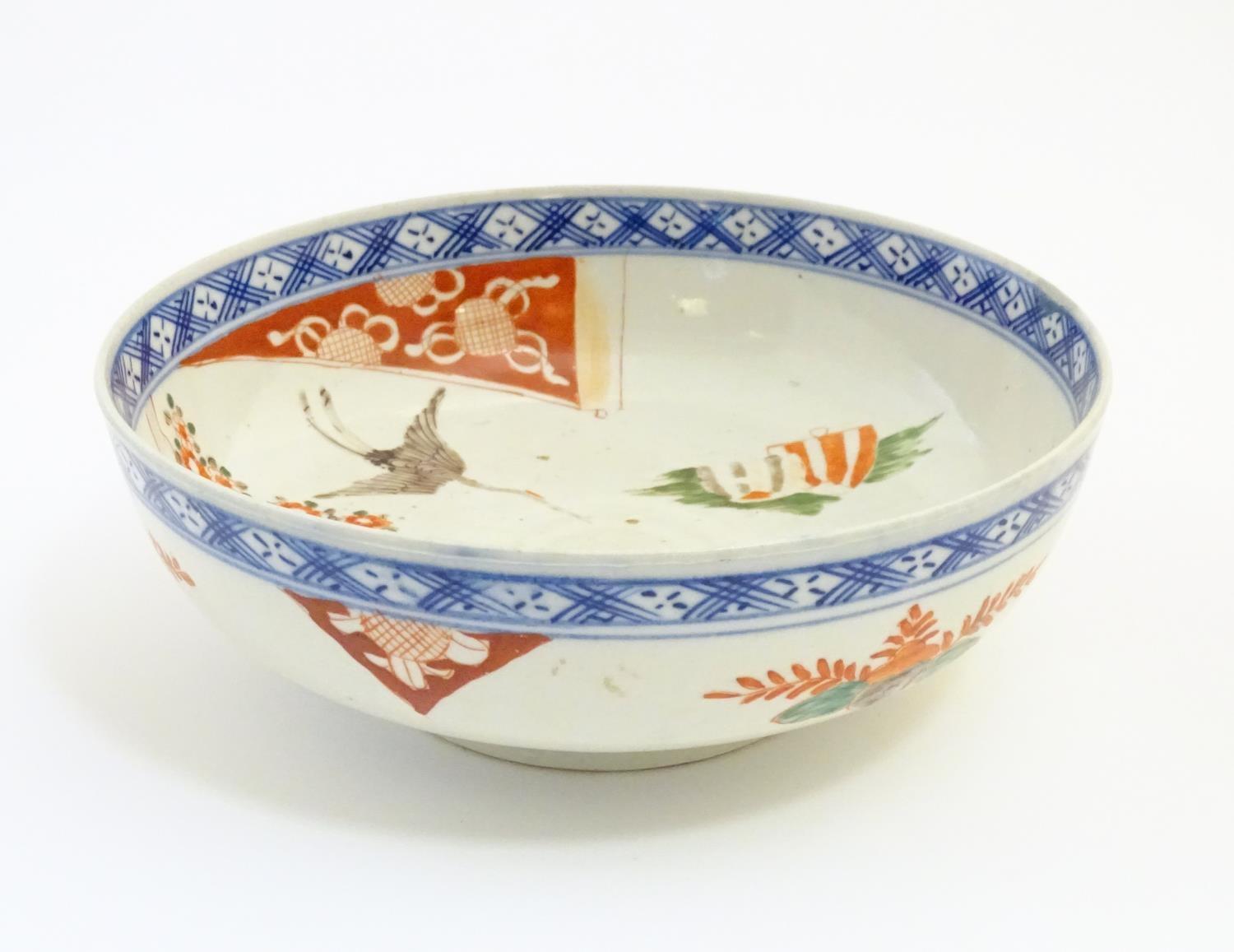 A Japanese bowl with hand painted decoration depicting a landscape scene with flowers, a crane - Image 7 of 7