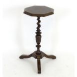 An early 18thC walnut candle stand with a burr walnut octagonal top, having crossbanded and