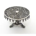 A white metal filigree miniature model of a centre table / dolls house table. Approx 2 1/4" high