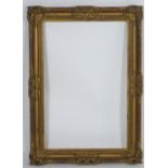 A gilt swept pattern frame. Approx. 25 1/2" x 16 1/2" Please Note - we do not make reference to