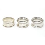 A pair of silver napkin rings hallmarked Birmingham 1927 maker E Edmonds together with another