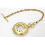 An Excalibur gold plated half-hunter pocket watch with gold plated watch chain. The white enamel