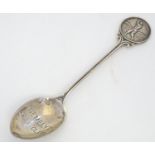 A silver spoon the handle surmounted by image of a golfer and the bowl engraved St. Melyd Golf Club.