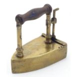 A Victorian small proportion brass iron with a wooden handle. Approx. 3 1/2" high Please Note - we
