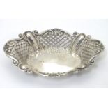 A silver pin dish with pierced and embossed decoration. Hallmarked Sheffield 1903 maker James