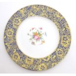 A Minton cabinet plate in the pattern Brocade with central floral motif. The blue border with gilt