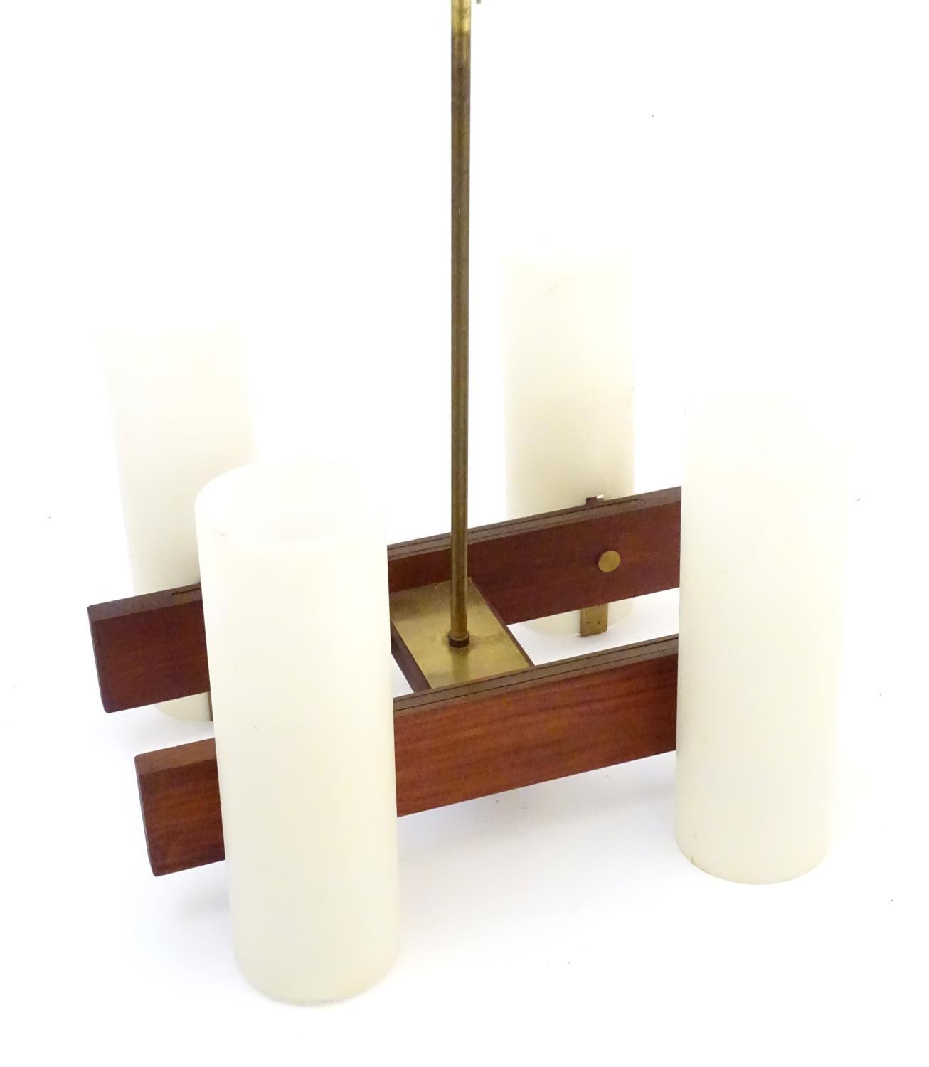 A vintage retro Danish pendant light fitting with four cylindrical shades in the style of Jo