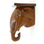 A carved wooden wall bracket modelled as the head of an elephant. Approx. 12" Please Note - we do