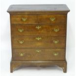 A mid / late 18thC oak chest of drawers with a rectangular moulded top above two short over three