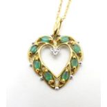 A 9ct gold pendant set with emeralds and diamond. The pendant approx. 1" long. The chain approx. 20"