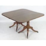 A Regency mahogany double pedestal dining table with turned supports, moulded shaped legs