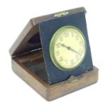 An Art deco travelling clock / timepiece within a wooden case The dial approx 2 1/2" diameter Please