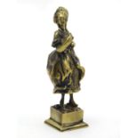 A 19thC brass model depicting a lady in 18thC dress. Approx. 4" high Please Note - we do not make