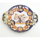 An Ashworth's Ironstone China twin handled plate decorated in the Imari palette with floral